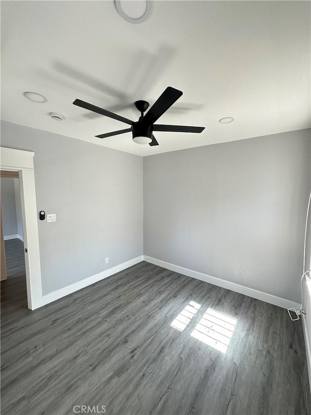 696 E 51st St E, Los Angeles, CA 90011 - empty room with ceiling fan, dark wood-style flooring, and a smoke detector