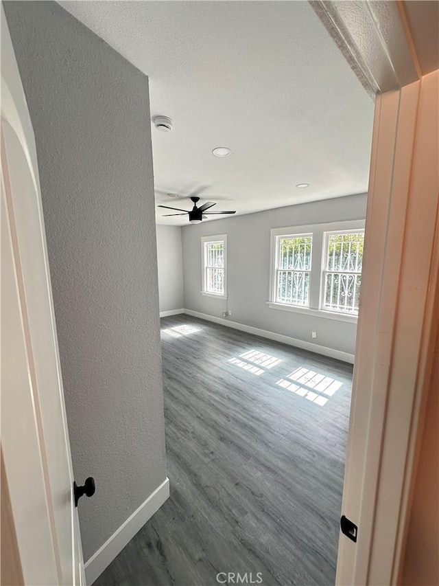 696 E 51st St E, Los Angeles, CA 90011 - empty room with a textured wall, a ceiling fan, dark wood-type flooring, and recessed lighting