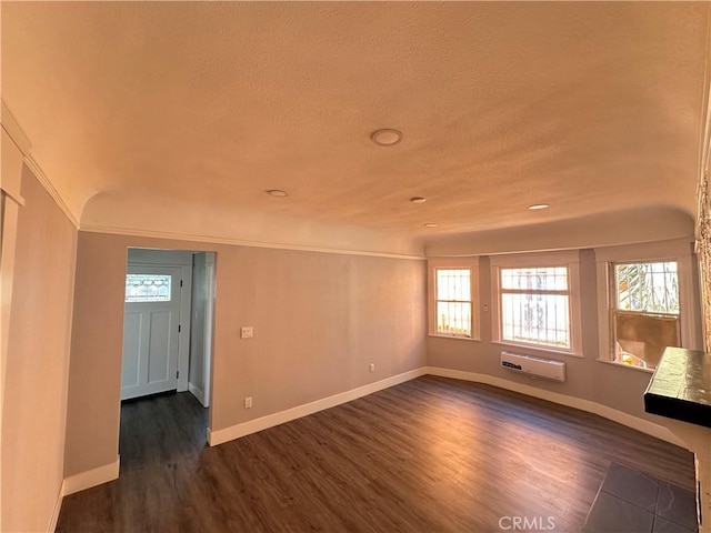 696 E 51st St E, Los Angeles, CA 90011 - unfurnished room featuring dark wood-style floors, a wall mounted air conditioner, and a textured ceiling