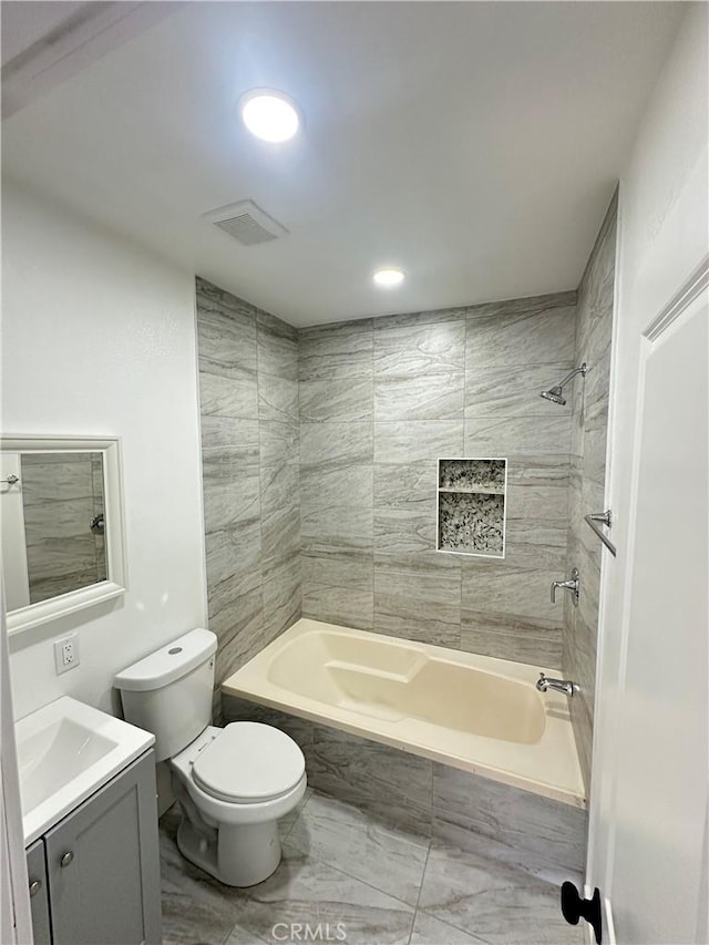 696 E 51st St E, Los Angeles, CA 90011 - bathroom with vanity, tiled shower / bath combo, marble finish floors, and recessed lighting