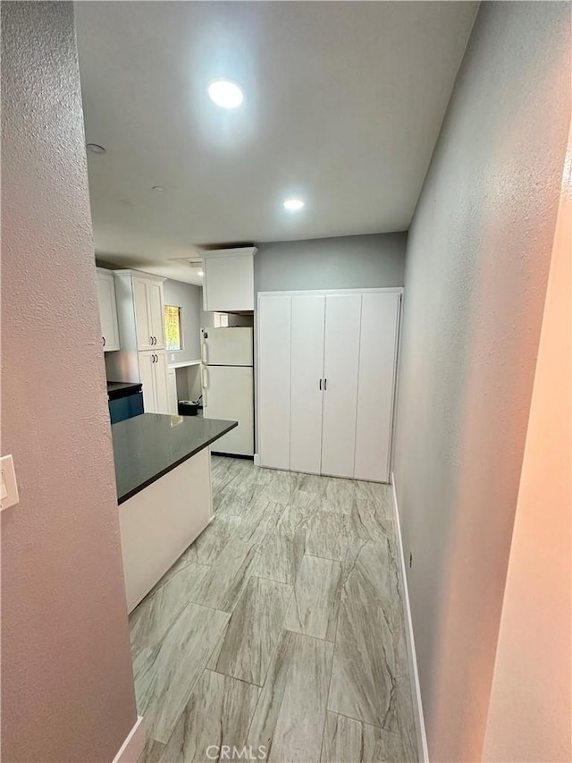 696 E 51st St E, Los Angeles, CA 90011 - kitchen featuring freestanding refrigerator, white cabinets, dark countertops, and recessed lighting