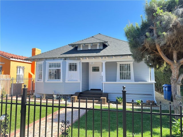 696 E 51st St E, Los Angeles, CA 90011 - bungalow-style home featuring a fenced front yard, a porch, and roof with shingles