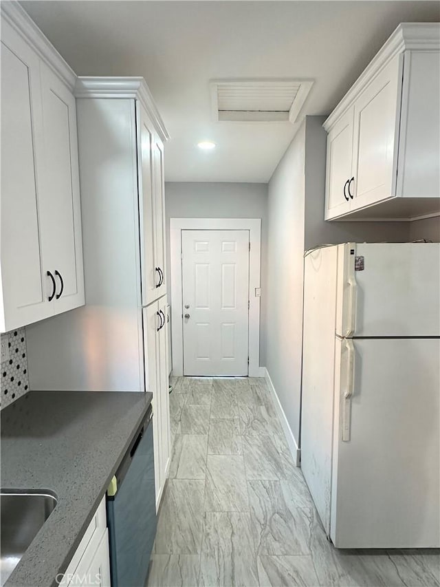 696 E 51st St E, Los Angeles, CA 90011 - kitchen with freestanding refrigerator, dishwasher, light marble finish flooring, white cabinetry, and dark stone countertops