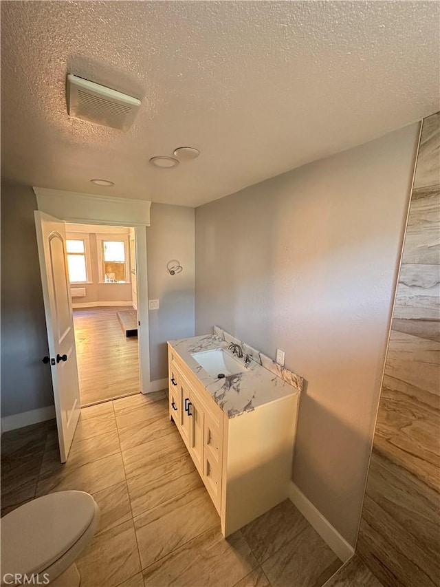696 E 51st St E, Los Angeles, CA 90011 - bathroom with a textured ceiling and vanity