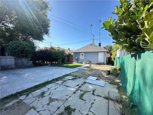 696 E 51st St E, Los Angeles, CA 90011 - rear view of house featuring a patio and a fenced backyard