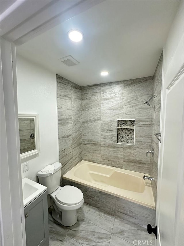696 E 51st St E, Los Angeles, CA 90011 - bathroom featuring marble look tiles, vanity, washtub / shower combination, and recessed lighting