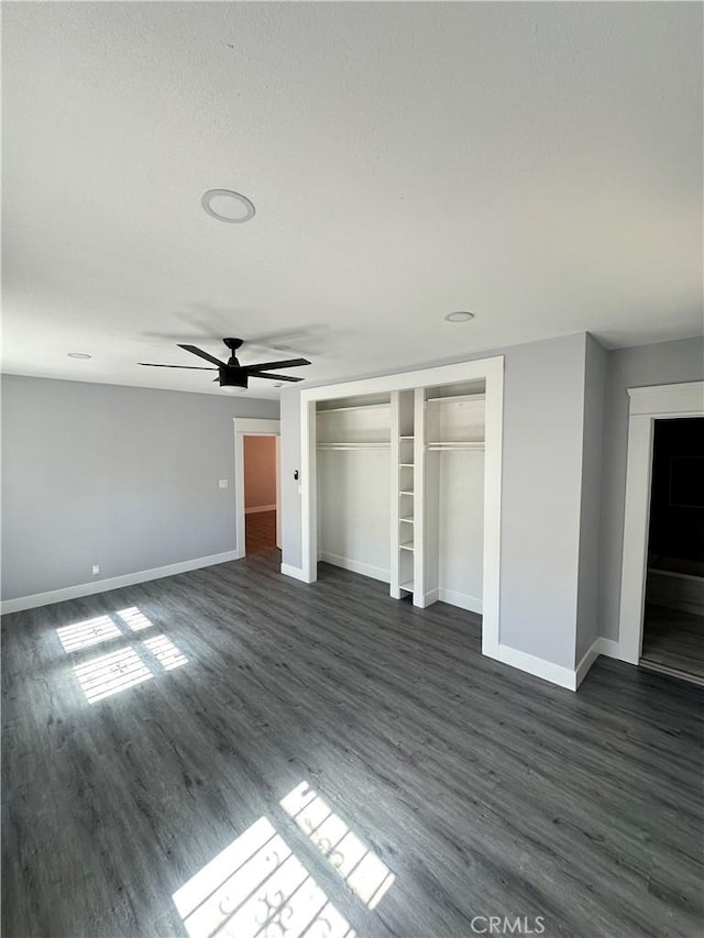 696 E 51st St E, Los Angeles, CA 90011 - unfurnished bedroom featuring dark wood-type flooring, a closet, and a ceiling fan