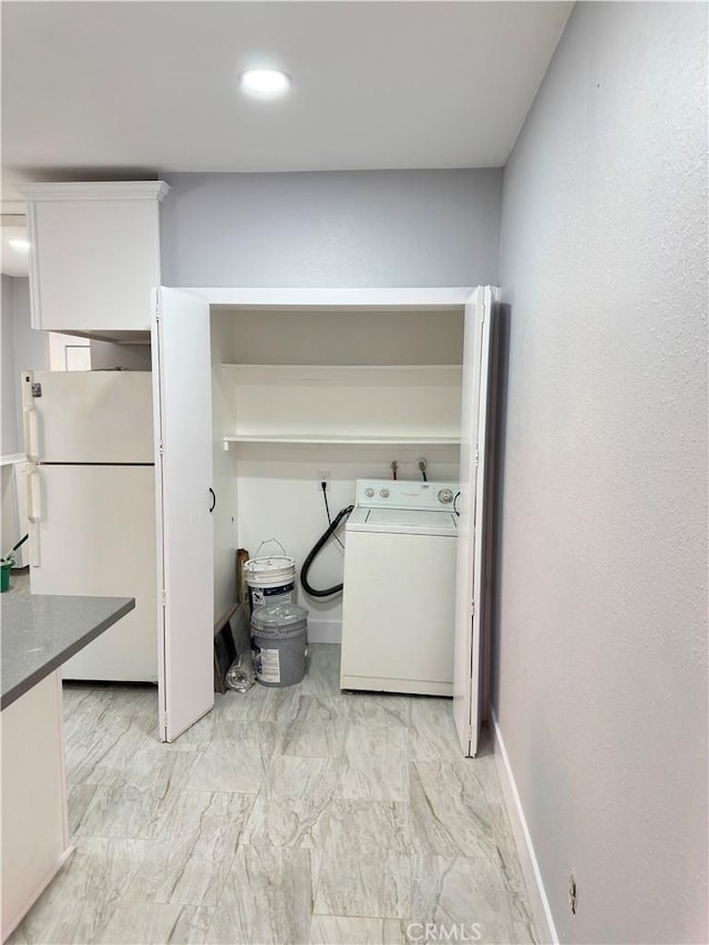 696 E 51st St E, Los Angeles, CA 90011 - washroom featuring washer / clothes dryer and light marble finish flooring
