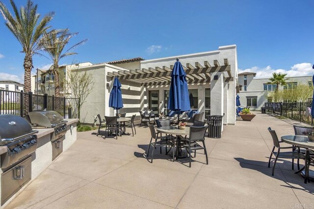 5140 Calle Sand Arch Unit 61, San Diego, CA 92154 - view of patio with a pergola, exterior kitchen, and outdoor dining area