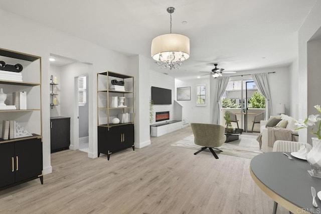 5140 Calle Sand Arch Unit 61, San Diego, CA 92154 - living room with a glass covered fireplace, light wood finished floors, a chandelier, and ceiling fan
