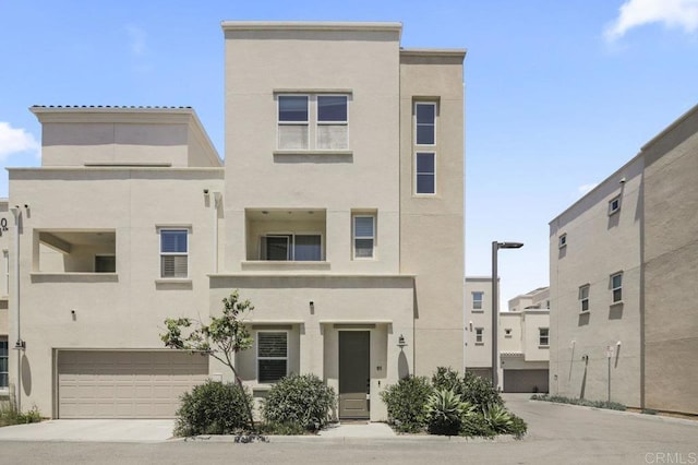 5140 Calle Sand Arch Unit 61, San Diego, CA 92154 - view of property with stucco siding, a garage, and driveway