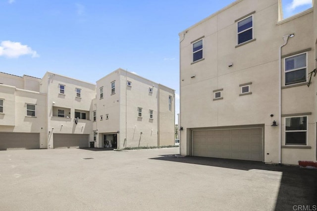 5140 Calle Sand Arch Unit 61, San Diego, CA 92154 - view of building exterior featuring a garage