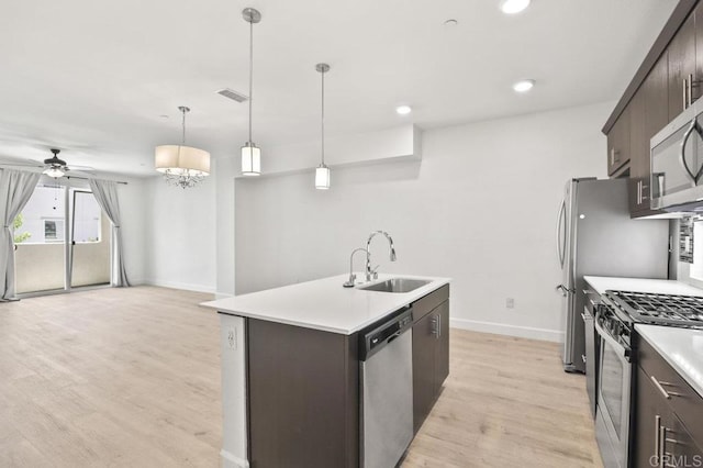5140 Calle Sand Arch Unit 61, San Diego, CA 92154 - kitchen with appliances with stainless steel finishes, dark brown cabinets, light wood finished floors, a ceiling fan, and recessed lighting