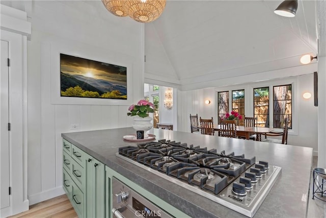 28233 N Shore Rd, Lake Arrowhead, CA 92352 - kitchen featuring green cabinetry, stainless steel gas stovetop, plenty of natural light, dark countertops, and vaulted ceiling