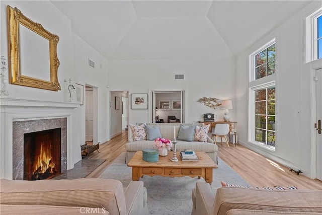 28233 N Shore Rd, Lake Arrowhead, CA 92352 - living room featuring high vaulted ceiling, light wood-style floors, and a high end fireplace