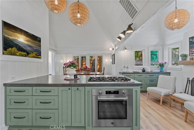 28233 N Shore Rd, Lake Arrowhead, CA 92352 - kitchen featuring green cabinets, appliances with stainless steel finishes, light wood-type flooring, dark countertops, and pendant lighting