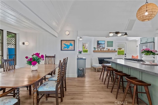 28233 N Shore Rd, Lake Arrowhead, CA 92352 - dining space featuring light wood-style flooring, a fireplace, and lofted ceiling