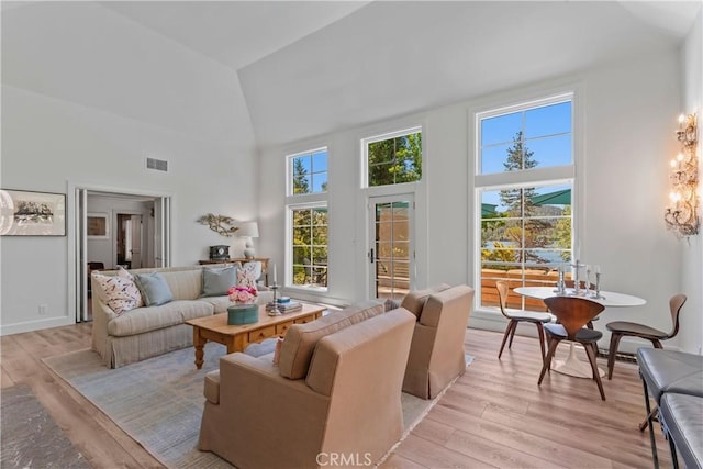 28233 N Shore Rd, Lake Arrowhead, CA 92352 - living area featuring high vaulted ceiling, light wood finished floors, and a chandelier