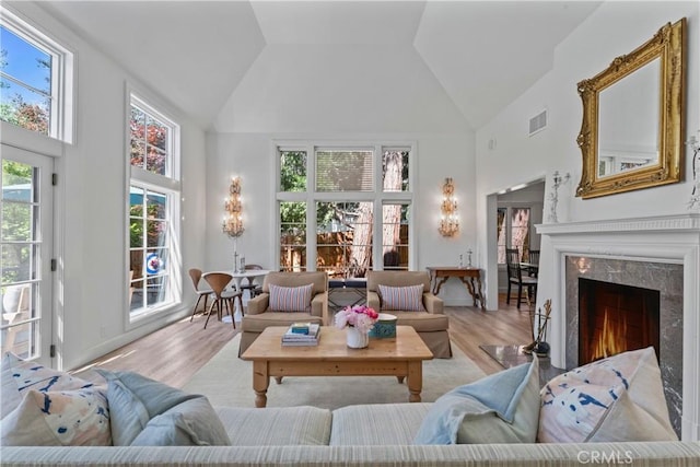 28233 N Shore Rd, Lake Arrowhead, CA 92352 - living room with high vaulted ceiling, wood finished floors, and a premium fireplace