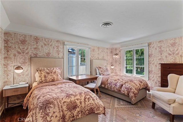 28233 N Shore Rd, Lake Arrowhead, CA 92352 - bedroom featuring wallpapered walls, multiple windows, and wood finished floors