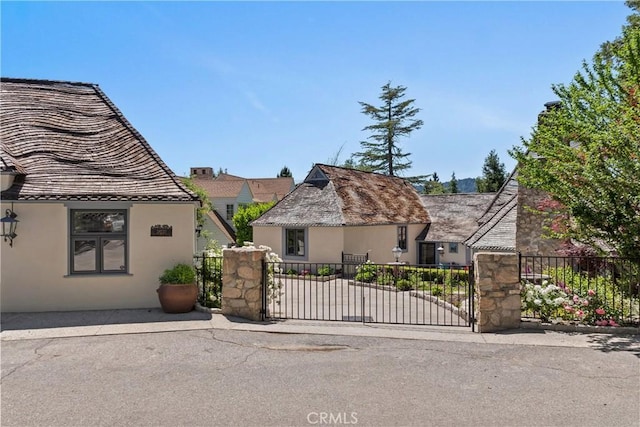 28233 N Shore Rd, Lake Arrowhead, CA 92352 - view of front of house featuring stucco siding and a gate