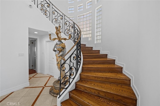 759 Foxkirk Rd, Glendale, CA 91206 - stairs with inlaid floor details, tile patterned floors, a towering ceiling, and recessed lighting
