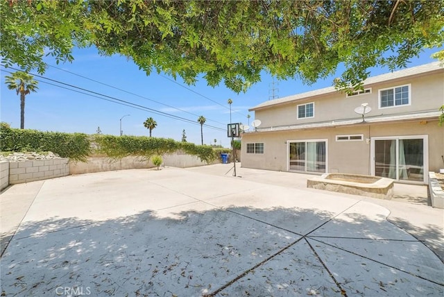 5005 Pearblossom Dr, Riverside, CA 92507 - back of house featuring stucco siding, a patio, and a fenced backyard