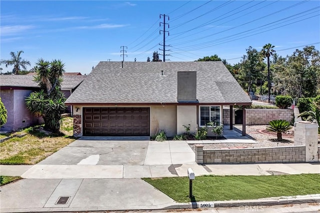 5005 Pearblossom Dr, Riverside, CA 92507 - view of front facade featuring an attached garage, stucco siding, concrete driveway, and roof with shingles