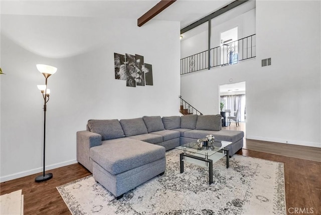 5005 Pearblossom Dr, Riverside, CA 92507 - living area featuring beam ceiling, wood finished floors, a towering ceiling, and stairs
