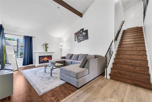 5005 Pearblossom Dr, Riverside, CA 92507 - living room featuring wood finished floors, stairs, beamed ceiling, a fireplace, and high vaulted ceiling