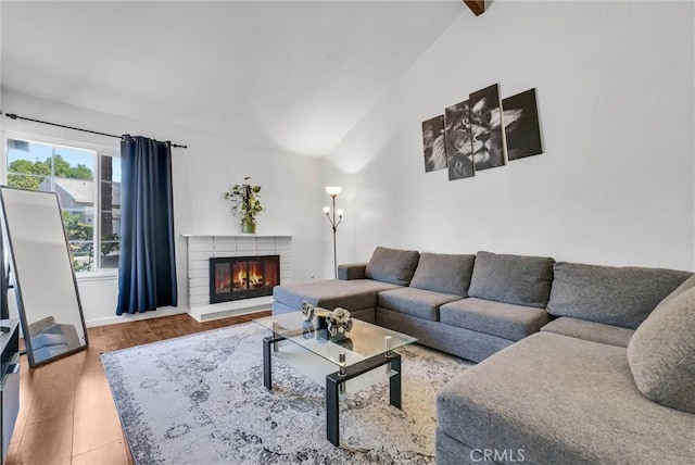 5005 Pearblossom Dr, Riverside, CA 92507 - living area with a fireplace, wood finished floors, and high vaulted ceiling