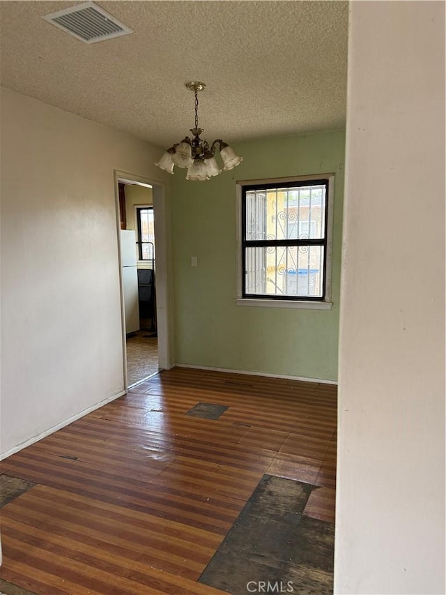 1317 S Baker St, Santa Ana, CA 92707 - spare room with a chandelier, wood finished floors, and a textured ceiling