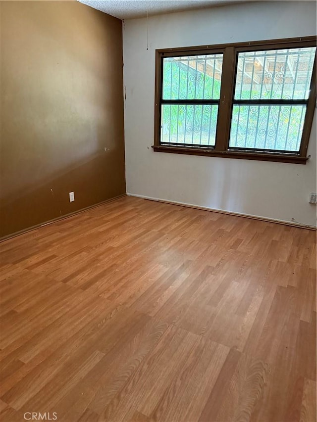 1317 S Baker St, Santa Ana, CA 92707 - unfurnished room with light wood finished floors and baseboards