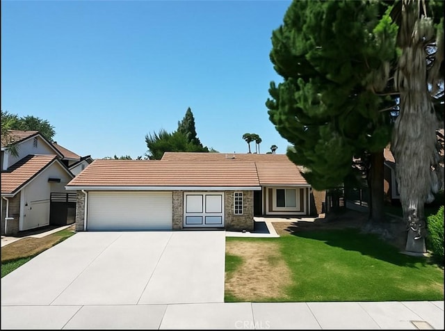 5416 Civetta Ln, Riverside, CA 92505 - view of front of home featuring a garage, a tile roof, driveway, and stone siding