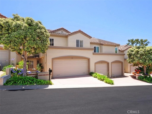 34 Via Capri, Rancho Palos Verdes, CA 90275 - view of front of home with stucco siding, an attached garage, a tile roof, and concrete driveway