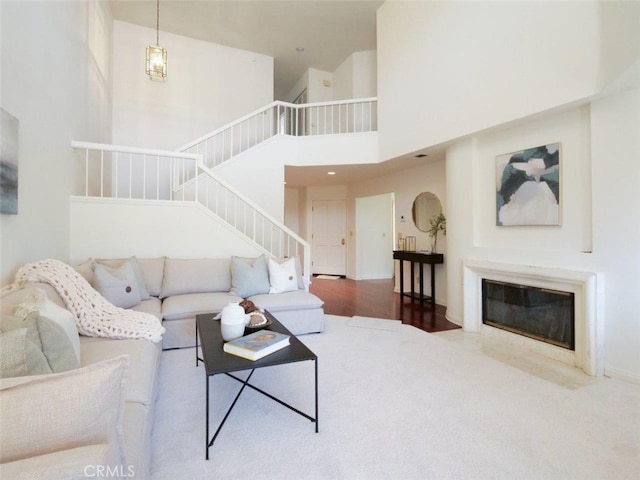 34 Via Capri, Rancho Palos Verdes, CA 90275 - living room with stairs, a towering ceiling, and a fireplace with flush hearth
