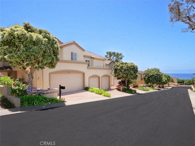 34 Via Capri, Rancho Palos Verdes, CA 90275 - mediterranean / spanish-style home with stucco siding, a garage, a tile roof, and driveway