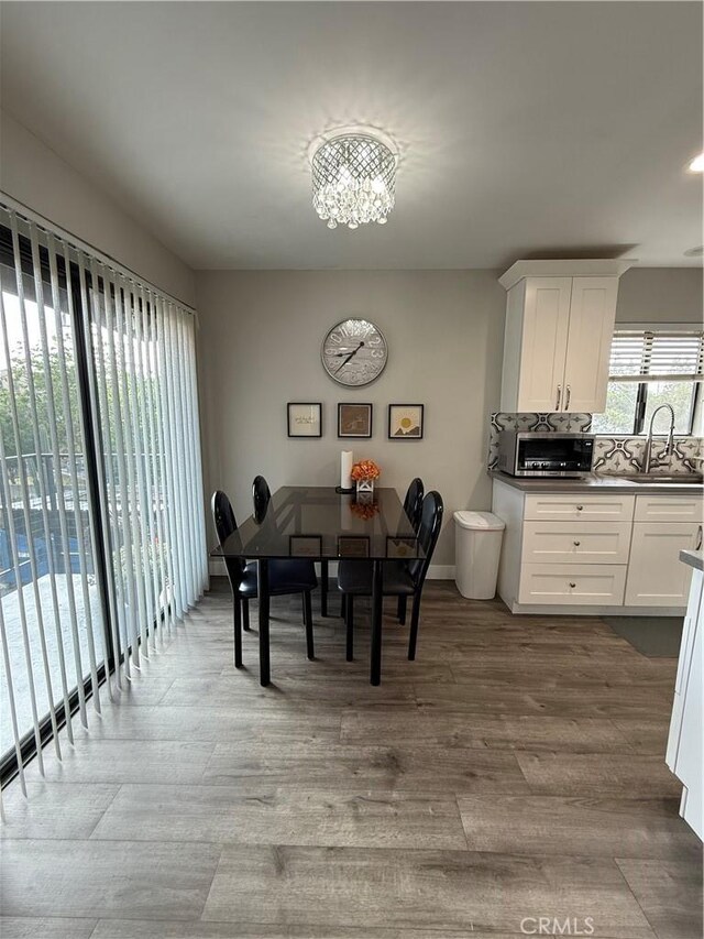 3935 W Mcfadden Ave Unit D, Santa Ana, CA 92704 - dining space featuring a chandelier and wood finished floors