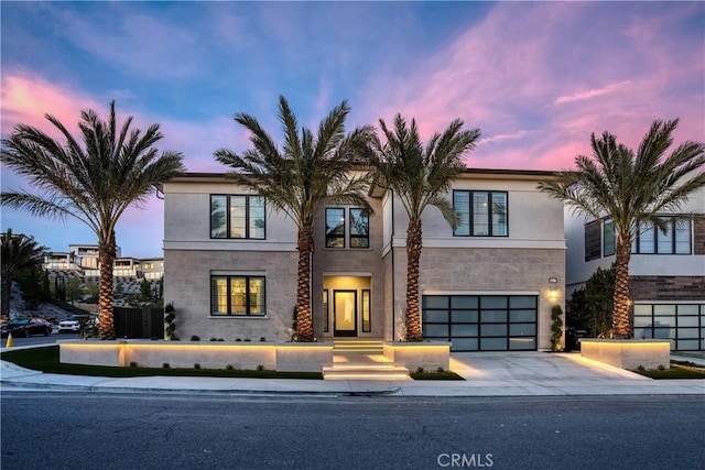 20211 W Liverpool Way, Porter Ranch, CA 91326 - contemporary house featuring driveway, a garage, stone siding, and stucco siding