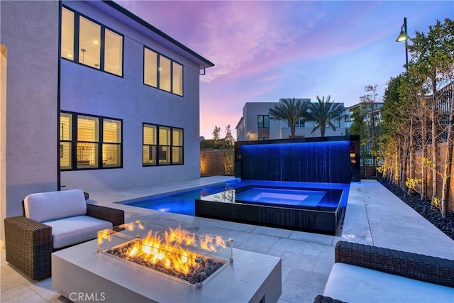 20211 W Liverpool Way, Porter Ranch, CA 91326 - pool at dusk with an in-ground hot tub, an outdoor fire pit, a patio, and a fenced backyard
