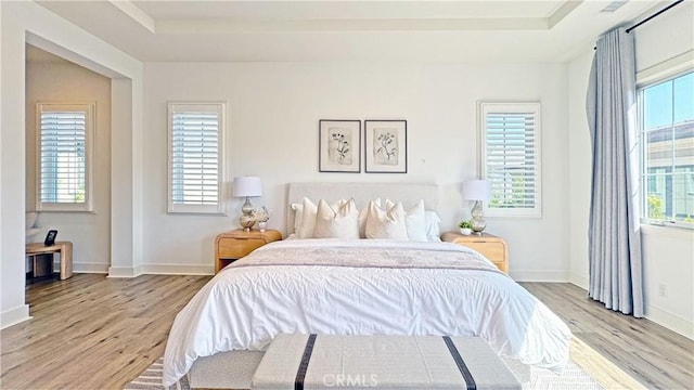 80 Interstellar, Irvine, CA 92618 - bedroom featuring light wood-style flooring and a raised ceiling