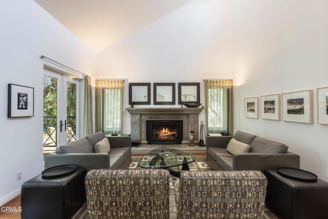 1040 Hillcroft Rd, Glendale, CA 91207 - living room featuring high vaulted ceiling, wood finished floors, a lit fireplace, and french doors