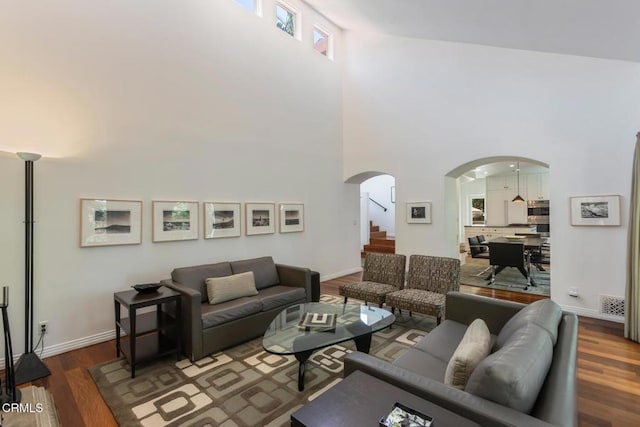 1040 Hillcroft Rd, Glendale, CA 91207 - living area featuring a towering ceiling, arched walkways, wood finished floors, and stairs