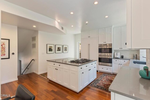 1040 Hillcroft Rd, Glendale, CA 91207 - kitchen with stainless steel double oven, gas stovetop, recessed lighting, backsplash, and dark wood-style flooring