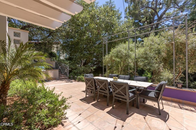 1040 Hillcroft Rd, Glendale, CA 91207 - view of patio featuring outdoor dining space, stairs, and view of scattered trees