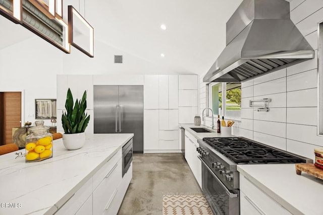 1305 Riviera Dr, Pasadena, CA 91107 - kitchen with wall chimney range hood, appliances with stainless steel finishes, modern cabinets, white cabinetry, and recessed lighting