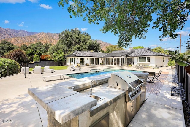 1305 Riviera Dr, Pasadena, CA 91107 - outdoor pool with exterior kitchen, a mountain view, a patio area, and an in-ground hot tub
