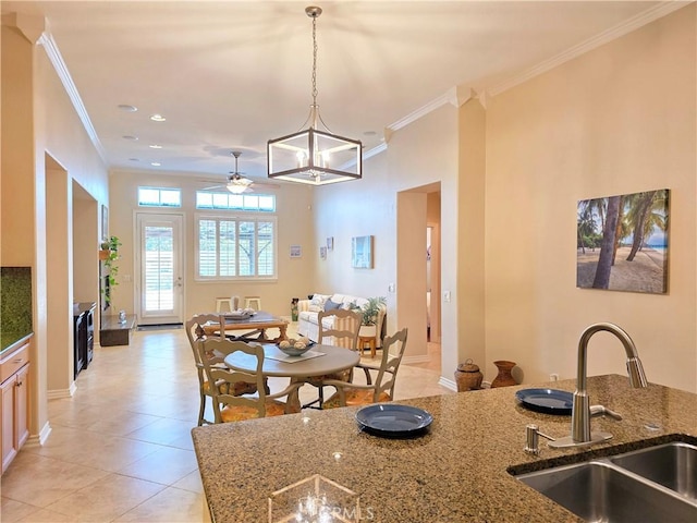 12833 Crestfield Ct, Rancho Cucamonga, CA 91739 - kitchen featuring ornamental molding, a ceiling fan, hanging light fixtures, dark stone counters, and light tile patterned floors
