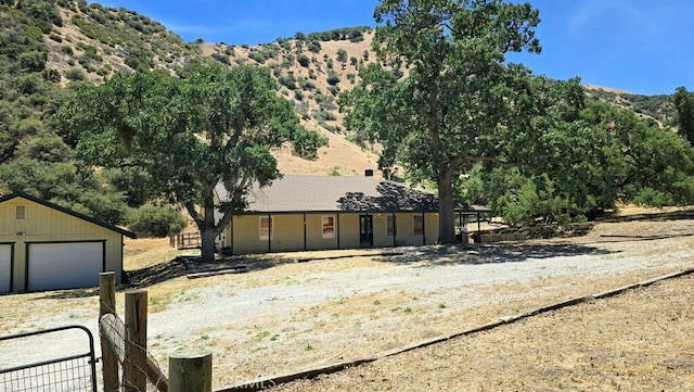 3020 Lebec Oaks Rd, Lebec, CA 93243 - view of front of house featuring a mountain view, an outbuilding, and a garage