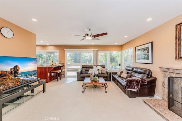 2771 Wyckersham Pl, Fullerton, CA 92833 - living room with a high end fireplace, ceiling fan, light colored carpet, and recessed lighting